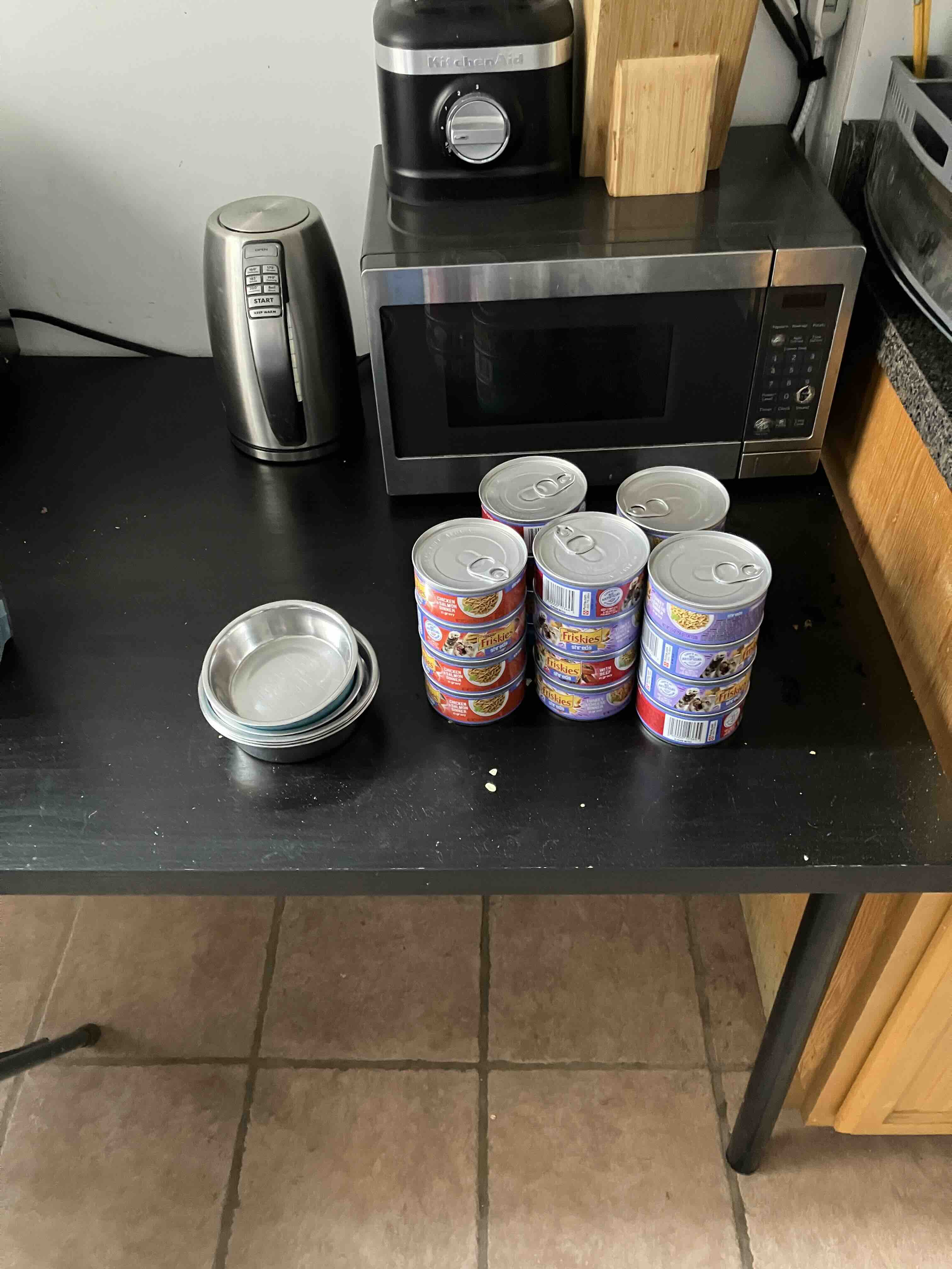 An image of the kitchen table with food and bowls on it.