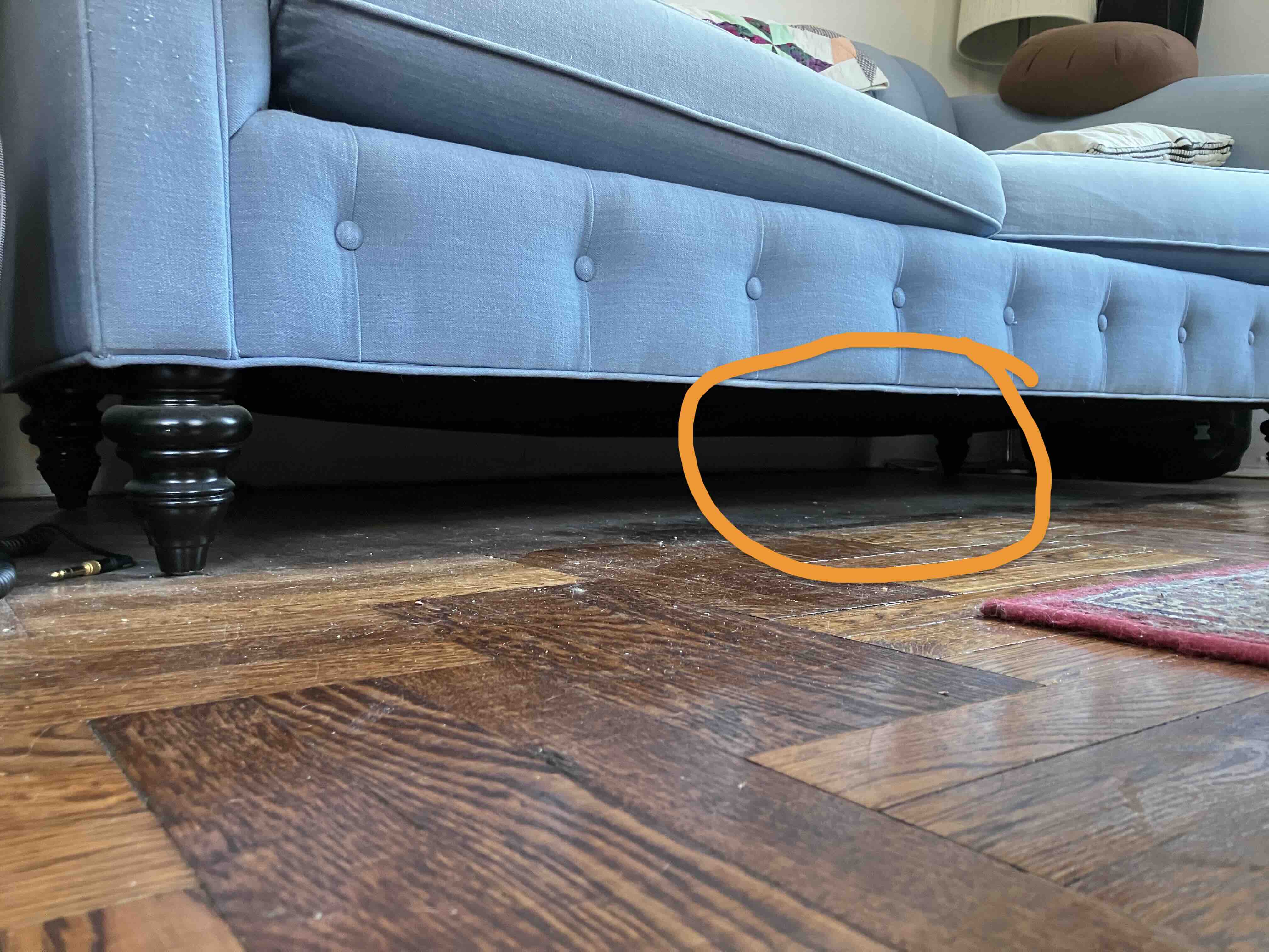 An image of the spot behind the couch where Pablo likes to hide.