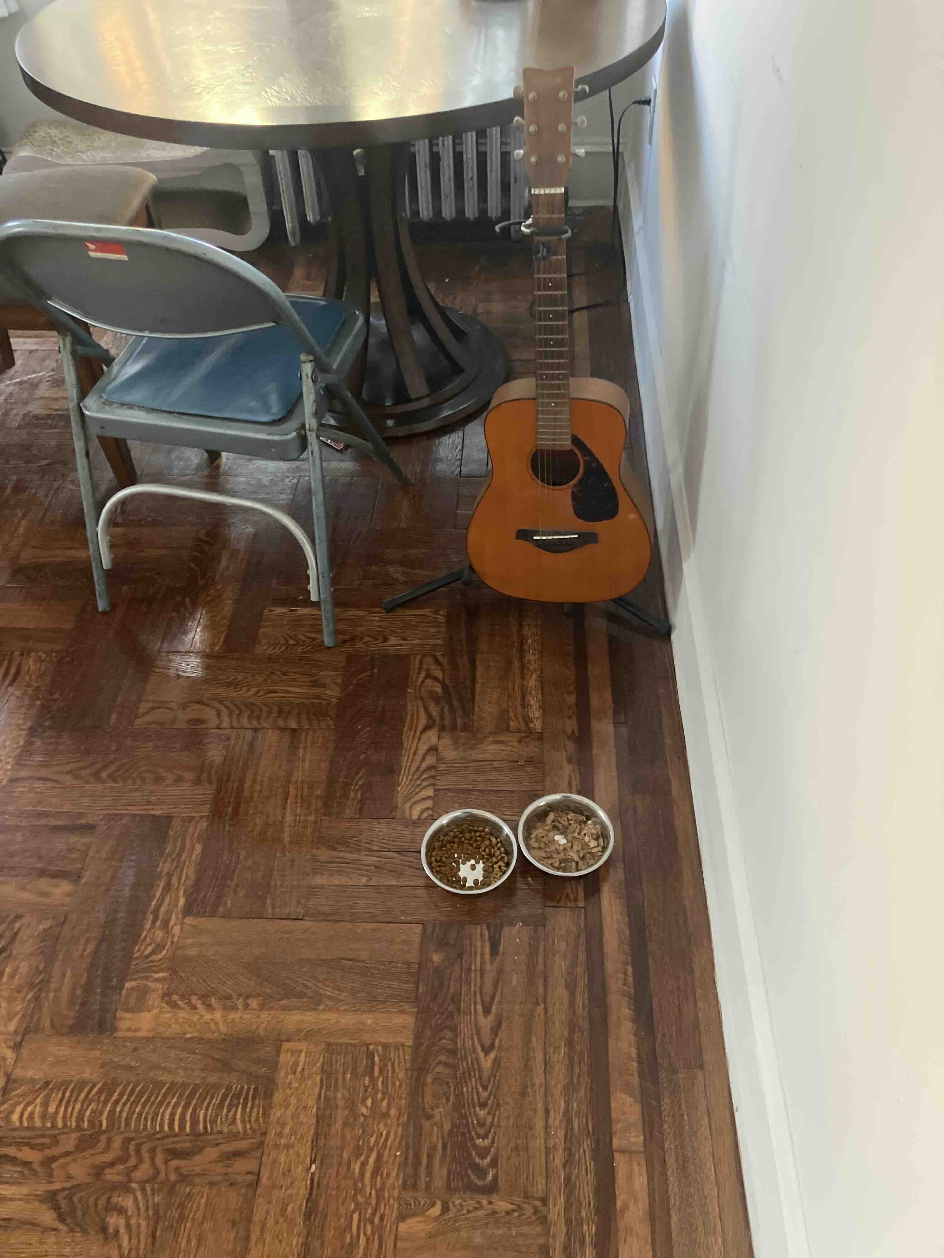 An image of the living room floor next to a guitar.